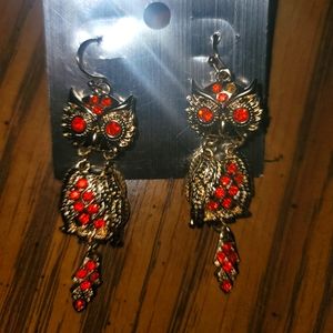 Gold and orange owl ear. Purchased but never worn. Nickel free. Made in China.